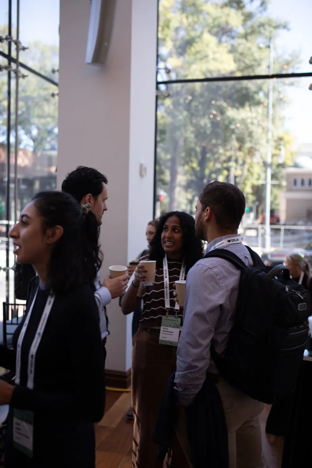 Leaders talking over coffee by the lobby windows